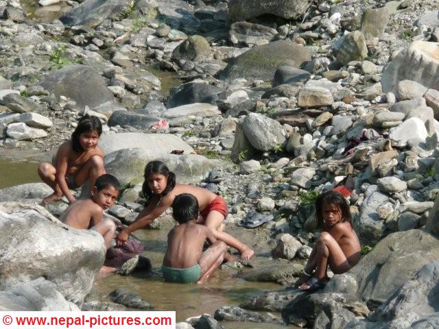Children washing in stream Arughat