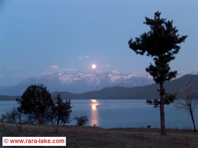 full moon rising above the lake